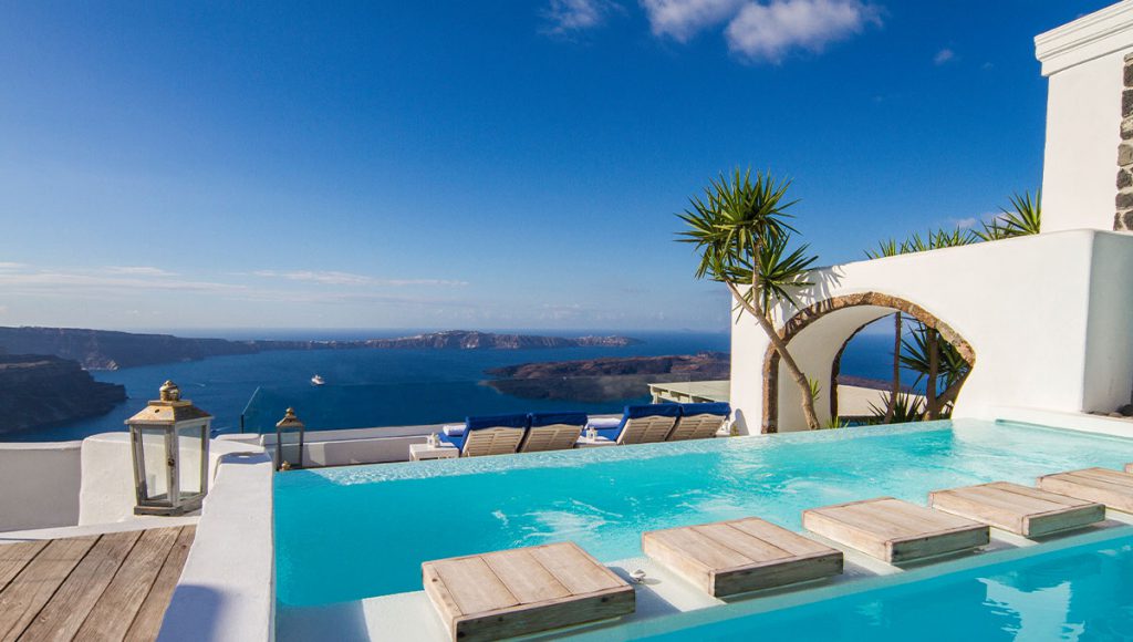 Iconic Santorini Hotel pool terrace view with sea in background