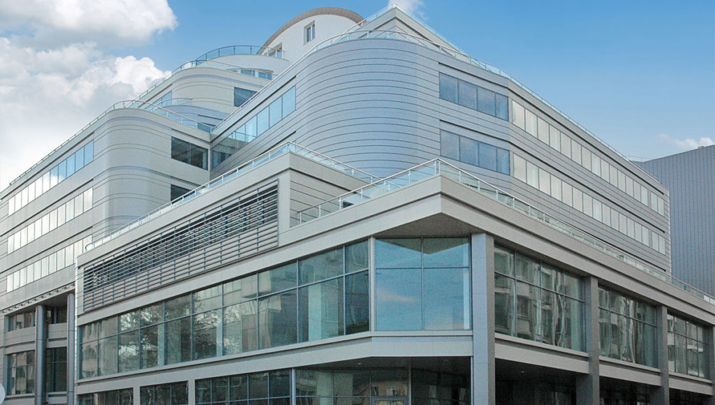 Side view from the street of Perform Business Center multiple balconies and offices