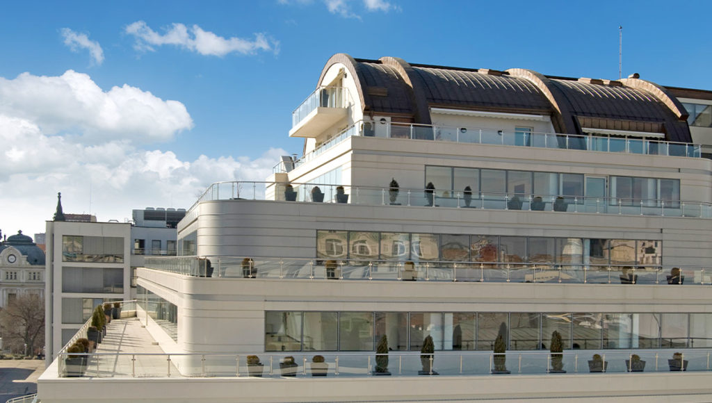 Perform Business Center side shot of balconies on three levels with a penthouse on top